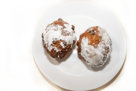 Dish with oliebollen, traditional Dutch pastry for New Years Eve isolated on white background, pastry, oil dumpling or fritterの写真素材