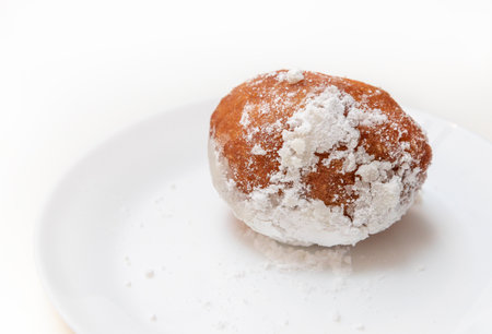 Dish with oliebollen, traditional Dutch pastry for New Years Eve isolated on white background, pastry, oil dumpling or fritterの写真素材