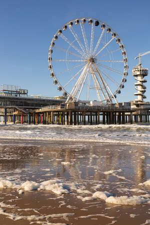 Scheveningen, The Hague, The Netherlands, 22 January 2021: Famous Pier from Scheveningen Strand, Den Haag - HOLLAND, the Netherlands. Under the pier and pier has colorful pillarのeditorial素材
