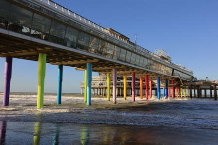 Scheveningen, The Hague, The Netherlands, 22 January 2021: Famous Pier from Scheveningen Strand, Den Haag - HOLLAND, the Netherlands. Under the pier and pier has colorful pillarのeditorial素材