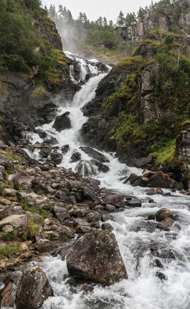 Waterfall among mountains in Norwayの写真素材