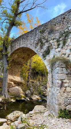 Stone bridge in the middle of the forest. in autumnの写真素材