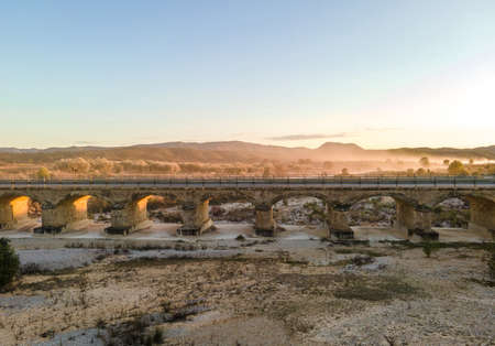 roman bridge over dry riverの写真素材