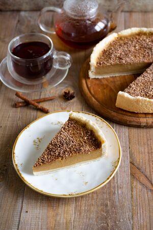 A piece of pumpkin cheesecake with chocolate on a beautiful plate. Vertical photoの写真素材