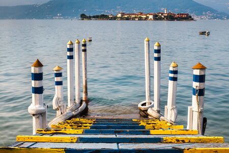 Colored wooden pier on the lake with island viewの写真素材