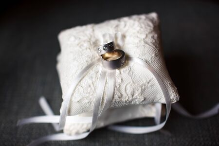 Gold and silver wedding rings on the pincushionの写真素材