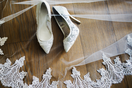 Wedding shoes and veil on the floor.の写真素材