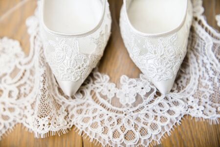 Wedding shoes and veil on the floor.の写真素材
