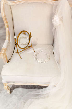 Wedding wreath, shoes and veil on the sofa.の写真素材