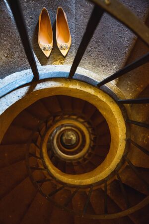 Wedding shoes on the steps of the spiral staircase.