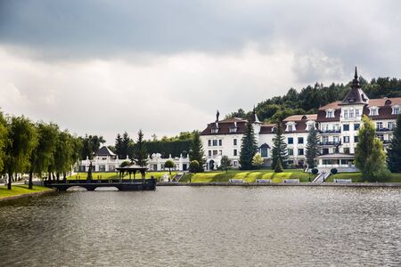 Large house in a forest on a lake.の写真素材
