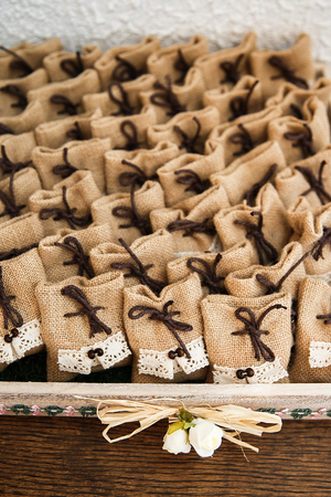 Many small brown bags of fabric on the tableの写真素材