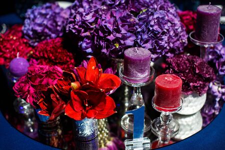 Candles and beautiful flowers on the wedding table. The table number.の写真素材
