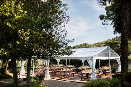 Tables sets for wedding or another catered event dinner. Courtyard of an Italian villa. Villa Bordoniの写真素材