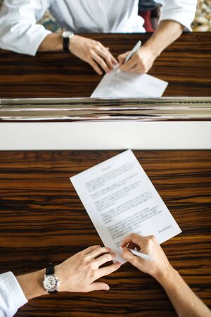 Groom is writing a letter to his beloved bride.の写真素材