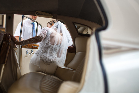 The bride and groom go from church to car.の写真素材