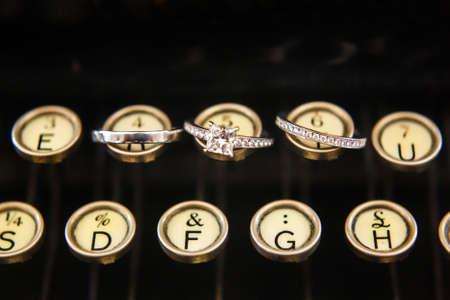 Three wedding rings on a typewriter. Wedding dayの写真素材