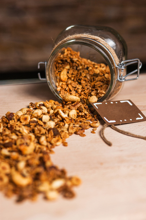 Homemade granola in glass jar on wooden backgroundの写真素材