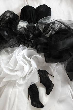 Black wedding shoes and wedding dress on the badの写真素材