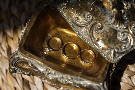 Three wedding rings in a vintage box.
