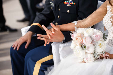 Newly wed couple's hands with engagement ring.の写真素材