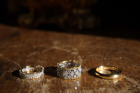 Three wedding ring on a black background.の写真素材
