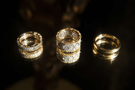 Three wedding ring on a black background.の写真素材