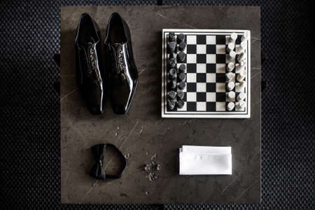 Wedding shoes of the groom next to the chessboard.の写真素材