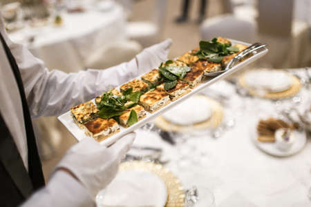 Blueberries and raspberries in glass bowls on a wedding table.の写真素材
