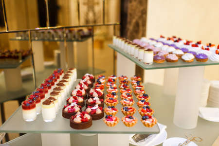 Blueberries and raspberries in glass bowls on a wedding table.の写真素材