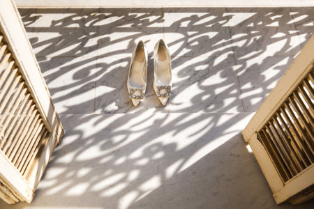 Beige wedding shoes on the marble floor.の写真素材