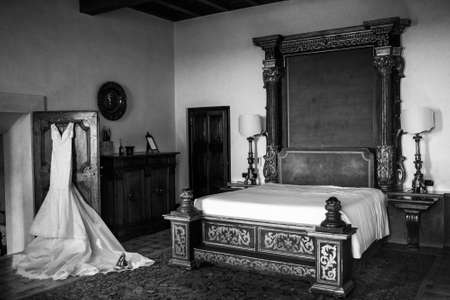 Wedding dress hanging on the door in the hotel room.の写真素材