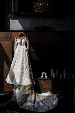 Wedding dress hanging on a stone wall.の写真素材