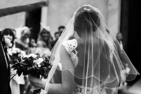 Little bridesmaids stand in front of the entrance to the church.の写真素材