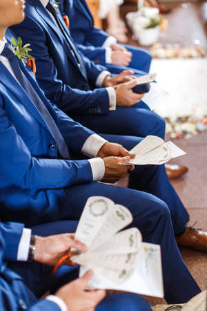 Little bridesmaids stand in front of the entrance to the church.の写真素材