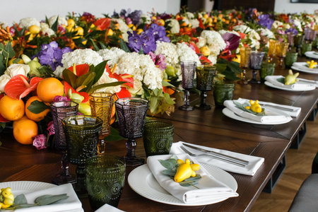 Arch for an outdoor wedding ceremony with flowers and fruits