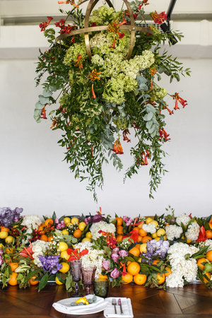 Arch for an outdoor wedding ceremony with flowers and fruitsの写真素材