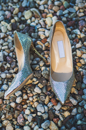 Shiny wedding shoes lie on the stones.の写真素材