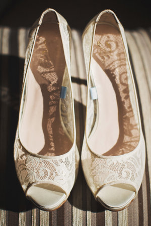 Lace wedding shoes stand on a striped background.の写真素材