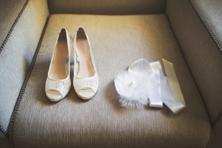 Lace wedding shoes stand on the sofa.の写真素材