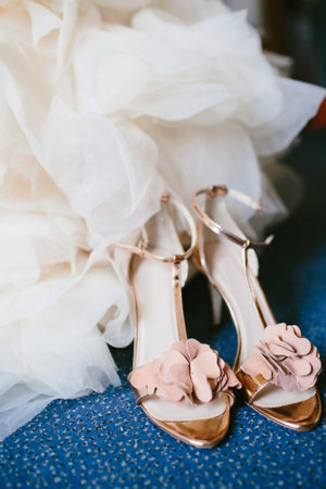 Pink shoes on the floor near the wedding dress.の写真素材