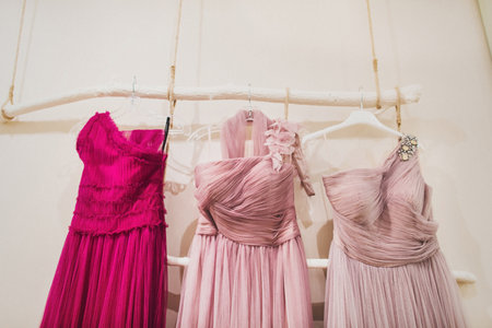 Bright dresses for bridesmaids hang on a hanger.の写真素材