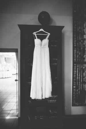 Wedding dress hangs on a wooden wardrobe.の写真素材