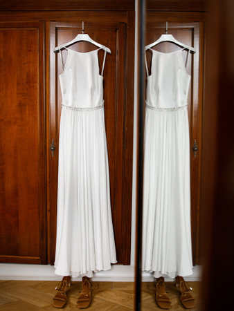 Brown shoes and wedding dress on the wardrobe.の写真素材