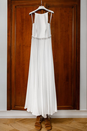 Brown shoes and wedding dress on the wardrobe.の写真素材
