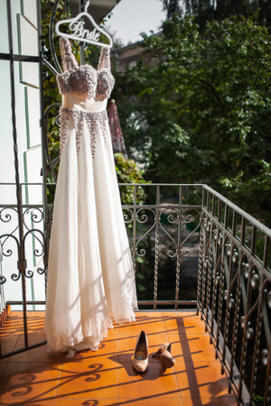 Wedding shoes and dress on the balcony.の写真素材