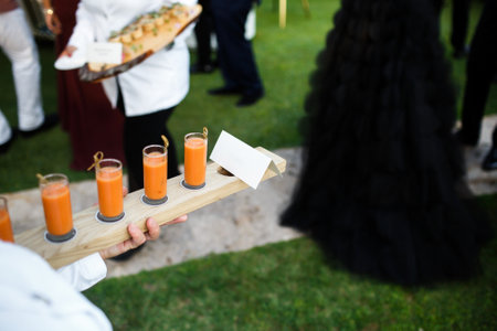 Appetizers in the hands of the waiter at the wedding.