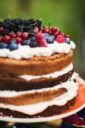 Multilevel wedding cake decorated with a variety of berries.の写真素材