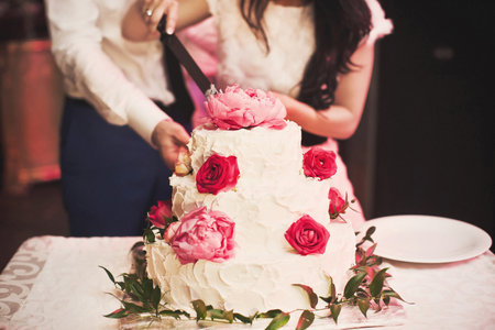 Multilevel wedding cake decorated with pink flowers.の写真素材