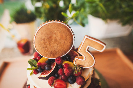 Multilevel wedding cake decorated with a variety of berries.の写真素材